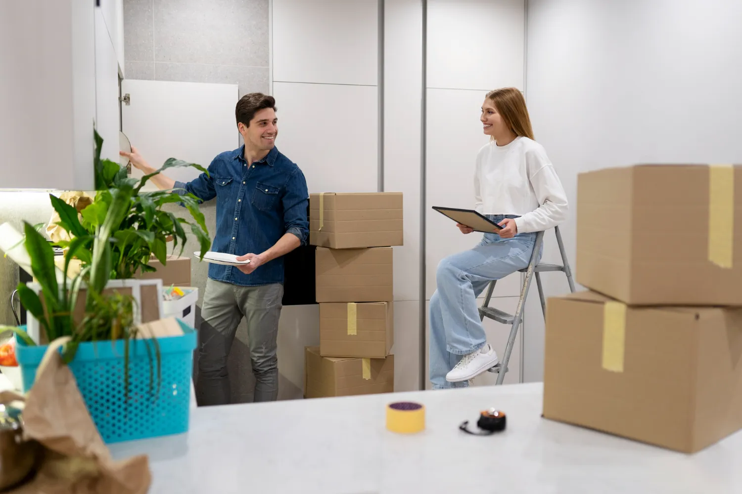 Two people unpacking boxes and planning in a new home