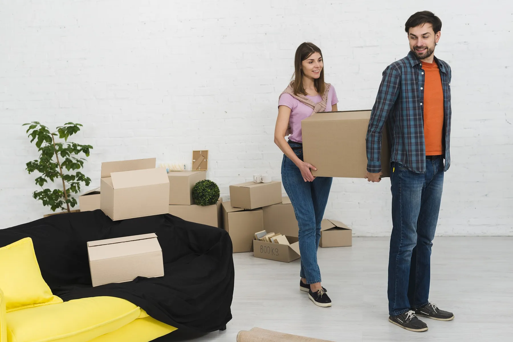 Couple standing with moving boxes in a new apartment